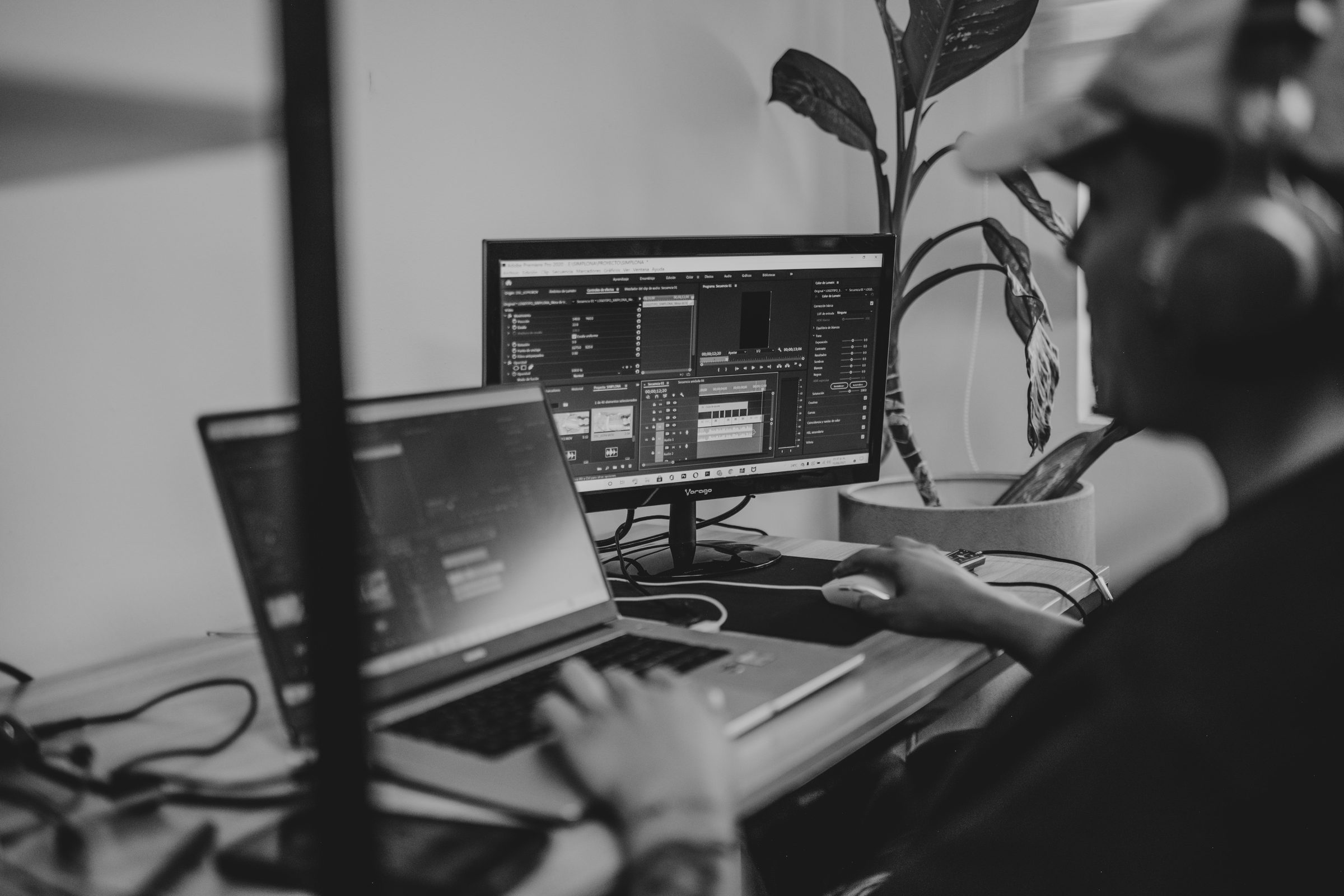 Person working at a laptop and monitor