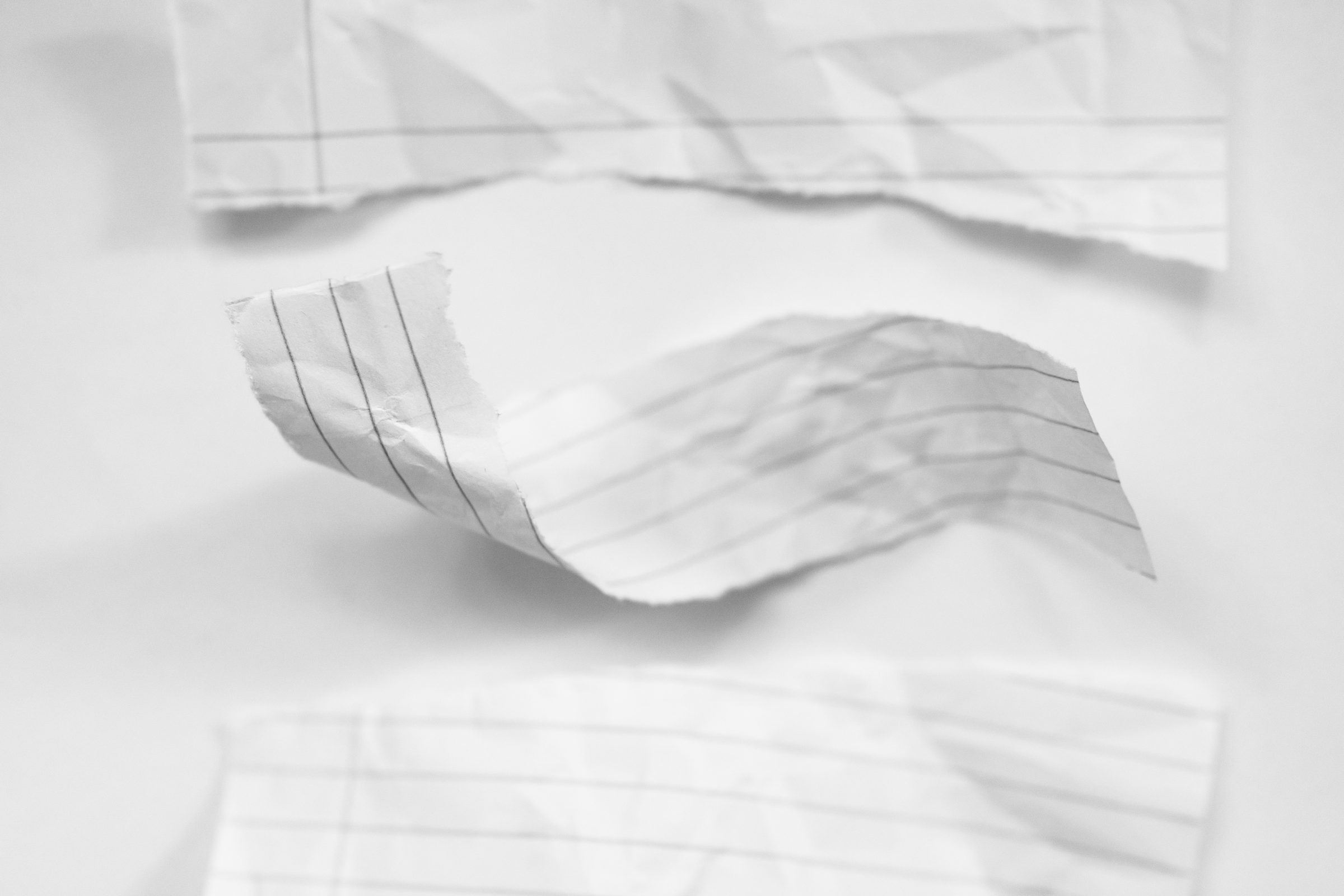 Torn strips of lined paper